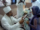 Mukaasir ud-Dawat Saiyedi Mohammad Nooruddin saheb (DM) giving hadiyah to Children who fasted the whole month of Ramazaan on Eid il-Fitr